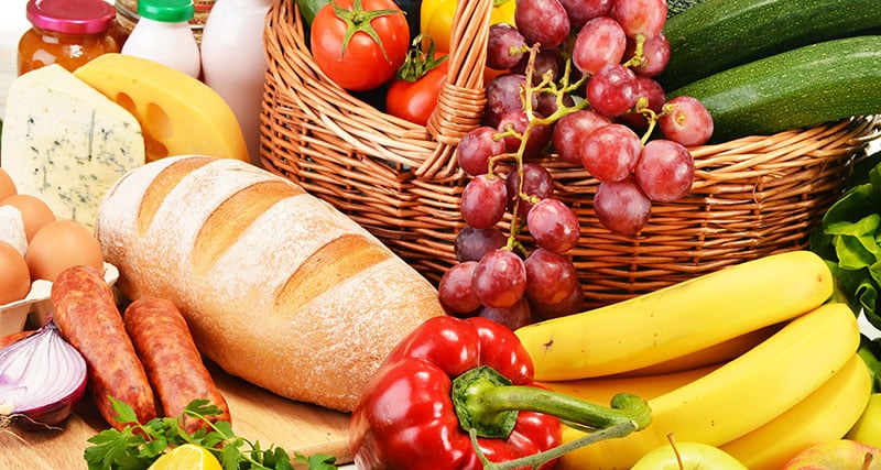 Assorted grocery products including vegetables fruits wine bread dairy and meat