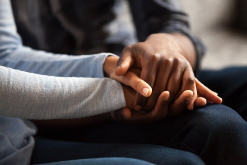Close-up of two people sitting side by side