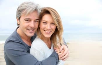 Cheerful cuddling mature couple