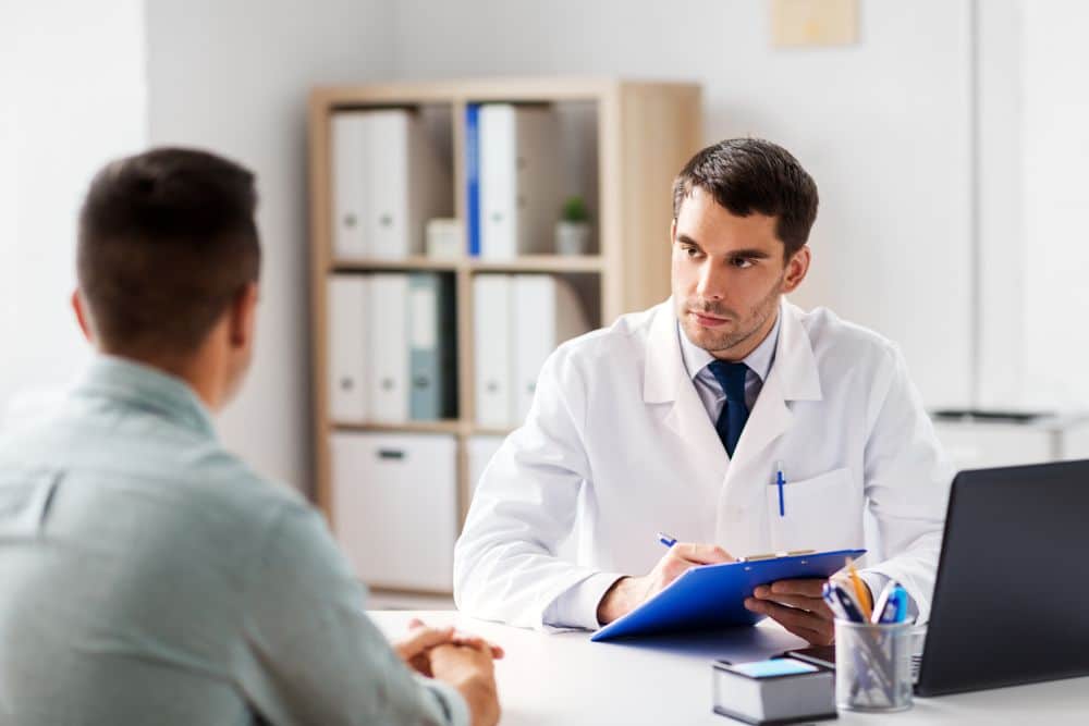 a man during a consultation at a male reproductive medicine and urological microsurgery specialist