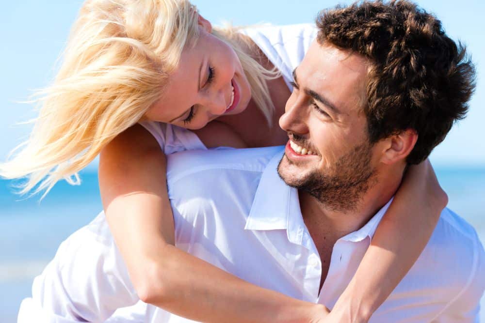 A happy couple in love spending time on the beach