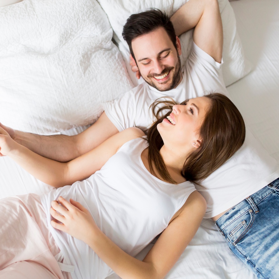 Young loving couple in the bed