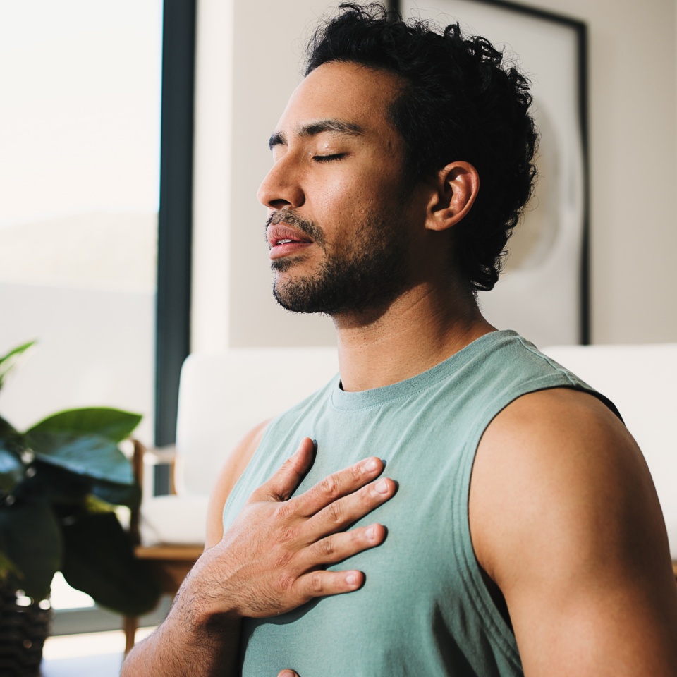 Meditation, calm man or home for breathing routine, relaxation or body awareness practice for wellness. Mindfulness, inner peace or person with holistic breathwork exercise, yoga or mental health zen.