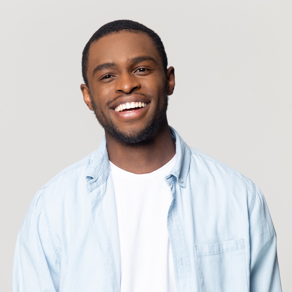 Head shot portrait happy African American man with wide healthy smile, satisfied client customer looking at camera, handsome young male feeling positive, isolated on grey background