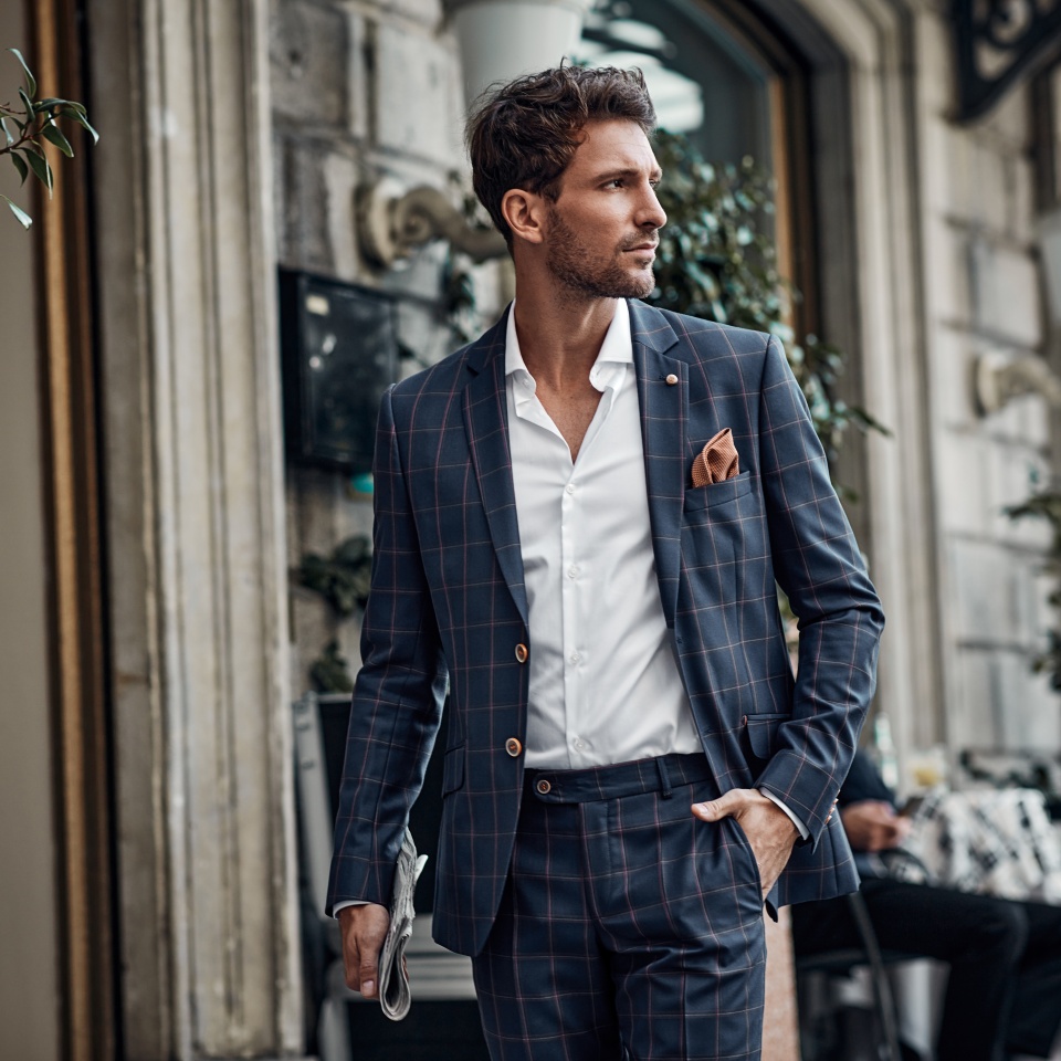 Handsome male model in checked suit walking on the street