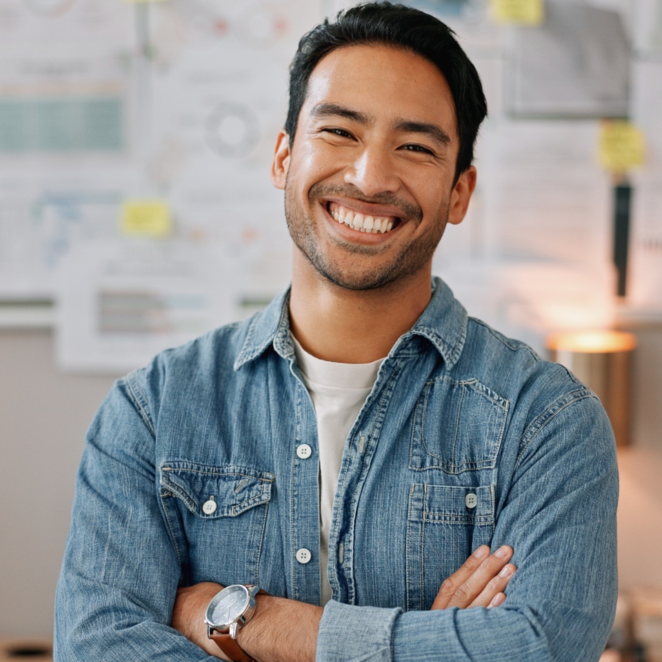 Business man, arms crossed and smiling face with creative worker and confident from admin consultant job. Happy, professional and portrait with entrepreneur employee for startup career at night.