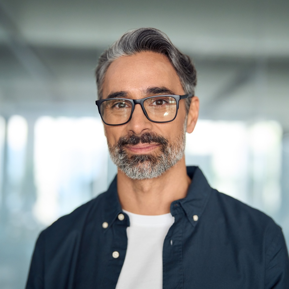 Happy middle aged professional business man, smiling mature executive ceo manager, 45 years old male entrepreneur, confident business owner wearing glasses in office. Headshot portrait.